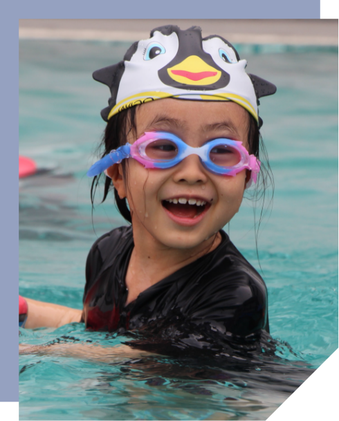 A child participates in swimming lessons during after-school activities at BXCL Penang